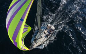 Overhead photo of a sailboat with green and purple sail