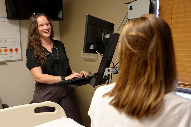 A UW School of Medicine WWAMI student smiles with their advisor at a clinic in Montana.